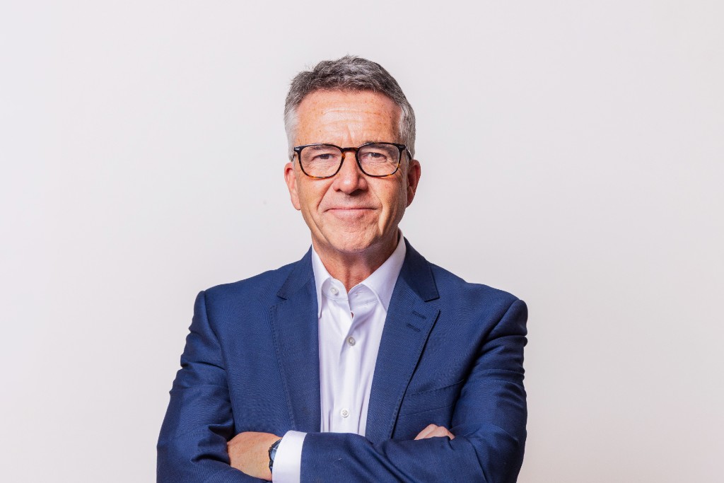 Paul McGee in a blue blazer with arms crossed
